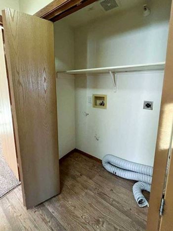 a laundry closet with washer and dryer hookups